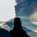 Girl staring at the eruption of a volcano. An explosion like this may have caused the volcanic winter of 536 CE.